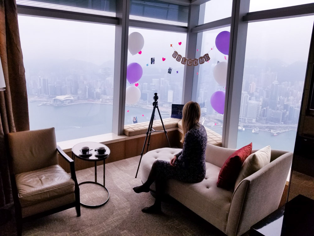 A girl looking at The view of the bay from a suite at The Ritz-Carlton